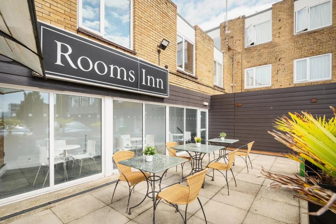 a restaurant with tables and chairs in front of a building at Rooms Inn near Newcastle city centre